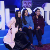 Team members seated on stage