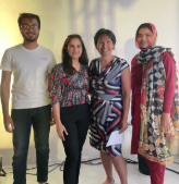 Four team members standing together